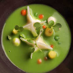 Cream of green peas soup with goat cheese ravioli